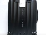 a black suitcase with a tag on it sitting on a table