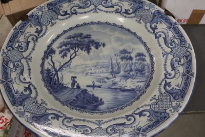 a blue and white plate with a picture of a boat on it