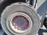 a tire that is sitting on the side of a truck
