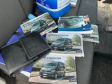 a black leather wallet sitting on the seat of a car