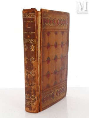 an old book sitting on top of a white table next to a white wall