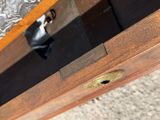 a close up of a wooden table with a metal handle