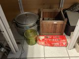 a box of food sitting on the floor next to a pot and pan
