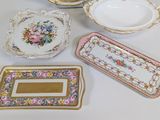 many different types of plates and trays on the table