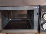 a microwave that is sitting on a wooden table