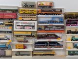 many different types of toy trains on display in a display case