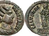 a silver coin with a bust of a woman and a bust of a man on it