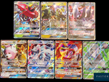 several pokemon cards are lined up on a black surface