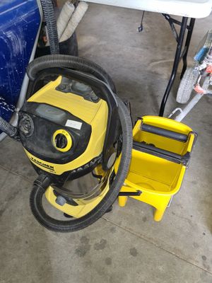 a yellow vacuum and a blue truck in a garage