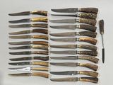 a lot of knives that are laying on a table