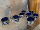 a silver and blue tea set on a glass table
