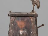 a statue of a bird sitting on top of a clock