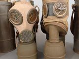 several gas masks are lined up in a row on a table