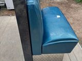 a blue couch that is sitting on the sidewalk