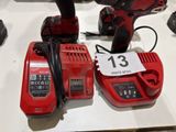 two red power tools are sitting on a table with a price tag