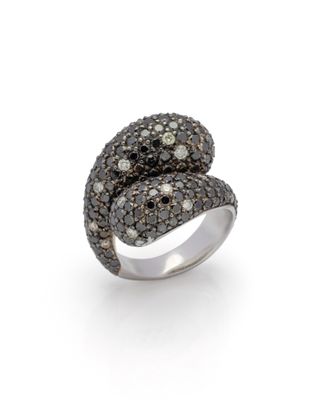 a close up of a ring with black and white diamonds