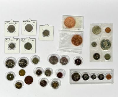 many different types of coins and small plastic containers