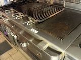 stainless steel counter top in a commercial kitchen with a grill on it