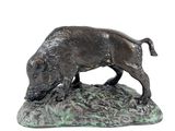 bronze statue of a boar on a rock on a white background
