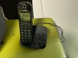 a cell phone sitting on top of a table next to a speaker