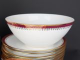 a stack of plates with a bowl on top of them