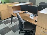 a desk with two computers and a chair in the room