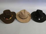 three hats are lined up on a white surface