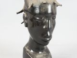a sculpture of a man with a goat ' s head on it ' s head