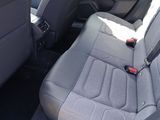 a seat in the back of a car with a remote in it