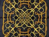 a close up of a square scarf with a design on it