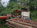 a pile of wood sitting in the middle of a field