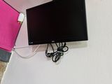 a flat screen tv mounted on the wall next to a wall mounted camera