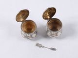 pair of antique silver plated cup and spoons on a white surface