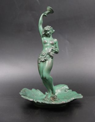 statue of a woman on a leaf holding a cup in her hand