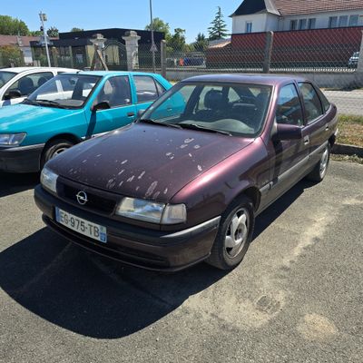 two cars parked next to each other in a parking lot
