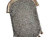 a silver purse with a chain and beads hanging from it