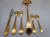 five different types of gold plated silverware on a white table