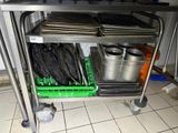 a metal cart with pots and pans on top of it