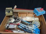 a box full of electronics and other items on a table