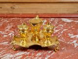 a gold plate with three candles on it on a marble table