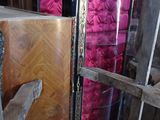 a tall cabinet with a glass door in the middle of a room