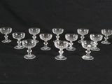 twelve glass goblets and cups on a black background