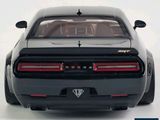 a black car with a red tail light on the back of it
