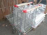 three shopping carts that are sitting on the ground