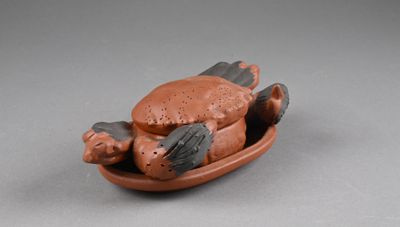 a small figurine of a cat on a plate
