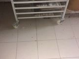 an image of a kitchen with a stove and a rack of donuts
