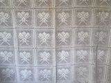 a white crocheted blanket with hearts on it