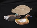 three ducks that are sitting next to each other on a table