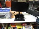 a desk with a computer monitor and a laptop on it