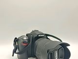 the camera has a lens attached to it ' s body